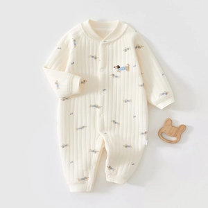 Detail of baby quilted romper featuring cute dog prints and soft ribbed cotton texture