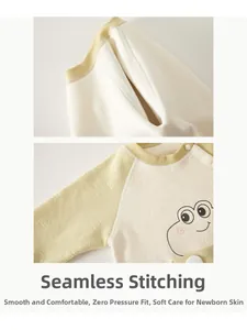 Detail of baby winter romper showing seamless sewing and cute frog pattern on fabric