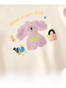 Detail of soft cream baby bodysuit with purple cartoon dog print and heart patterns