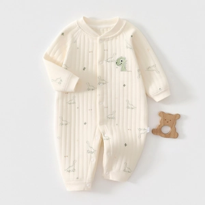 Detailed view of baby dinosaur cotton romper featuring cute green embroidery and rib knit texture