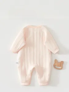 Detailed back view of pink quilted cotton baby romper with soft textured fabric