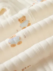 Quilted cotton baby bodysuit featuring cute brown bear print and bone-free sewing
