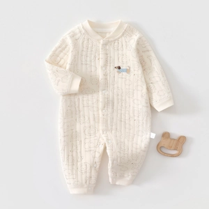 Detail of quilted cotton baby romper featuring cute animal prints and embroidered dog