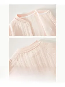 Close-up of pink baby romper neck with high-quality piping and snap button details