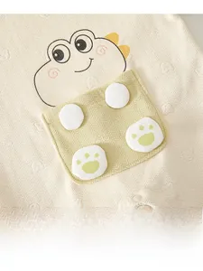 Detail of baby winter romper featuring cute dinosaur embroidery and textured fabric
