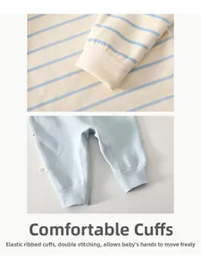 Detail of baby striped shirt cuffs and light blue pants with elastic ribbed hems