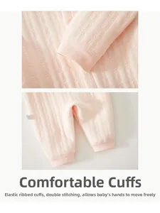 Close-up of pink baby bodysuit with ribbed cuffs and double stitching detail