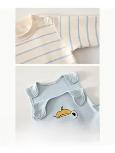 Detail of baby striped t-shirt showing resin snaps on shoulder for easy dressing