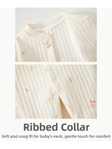 Close-up of ribbed cotton baby romper with cherry print and snap button neckline