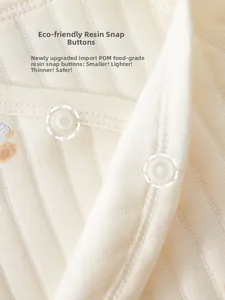 Detail view of baby bodysuit with safe, ultra-thin food-grade resin snap buttons