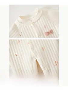 Close-up of resin snap buttons and soft waffle cotton fabric on baby cherry romper