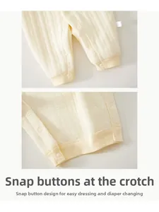 Detail view of snap buttons on baby romper for easy dressing and diaper changes