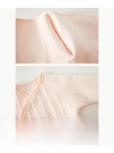 Detail of baby pink bodysuit featuring seamless stitching and oval embossed texture