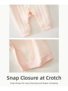 Detail of pink padded baby romper featuring snap buttons for easy diaper changes