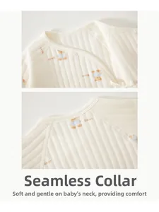 Detail of the bound neckline on quilted cotton baby bodysuit with cute bear print