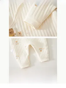 Close-up of baby romper showing cotton ribbed cuffs and cute embroidered bear detail