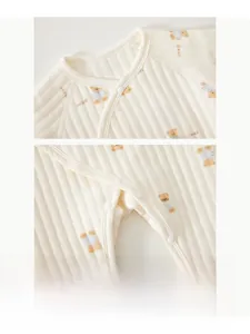 Close-up detail of infant cotton romper with resin snap buttons and bear pattern print
