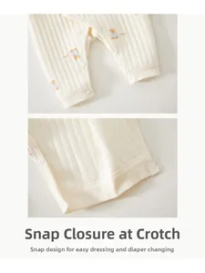 Detail of baby romper with bear print and snap button crotch for easy diaper changes