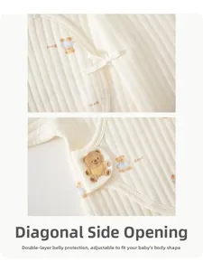 Detail of baby quilted cotton romper with side-tie closure and cute bear print pattern