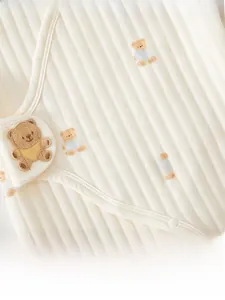 Detail of ribbed cotton baby romper with cute bear embroidery and snap-button closures