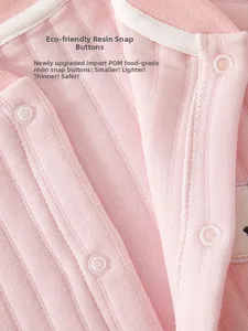 Detail of eco-friendly POM resin snaps on soft pink ribbed cotton baby bodysuit