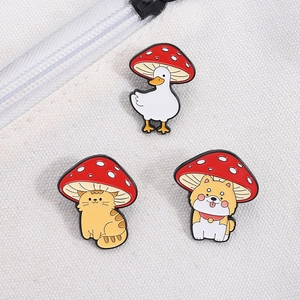 Detail of three cute animal enamel pins with mushroom hats on canvas backpack