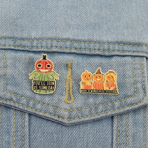 Halloween pumpkin scarecrow enamel pin set on blue denim jacket pocket accessory