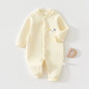 Detail of light yellow ribbed cotton baby romper with dog embroidery and front buttons