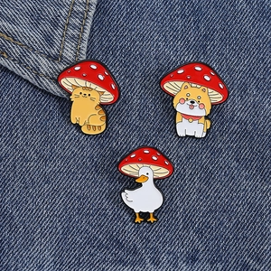 Close-up of animal pins with mushroom hats on denim, featuring cat, shiba, and duck
