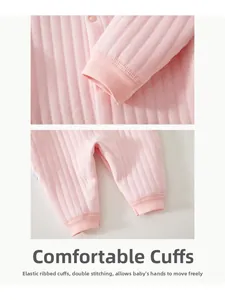 Detail of pink cotton baby romper showing ribbed elastic cuffs and reinforced stitching