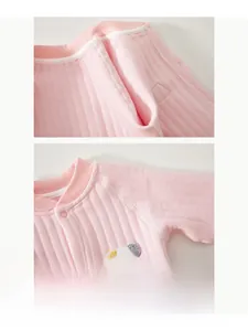 Detail of pink cotton baby romper featuring flat seams and cute puppy embroidery patch