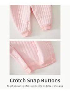 Detail view of pink quilted baby romper featuring convenient resin snap button closure