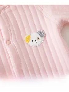 Detail of pink ribbed cotton baby romper featuring a cute 3D puppy embroidery patch