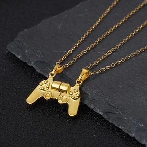 Close-up of magnetic game controller pendant necklaces in polished gold finish