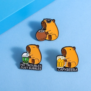 Three cute capybara enamel pins featuring funny beer and coconut drink designs