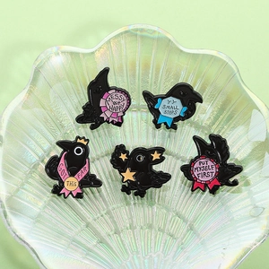 Funny crow enamel pins set of five with motivational quotes in a pearl glass bowl