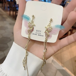 Detail of S925 silver butterfly earrings with pink blue gradient wings and tassel