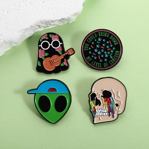 Enamel pin set featuring ghost, alien, skull, and quote badge on a soft green background