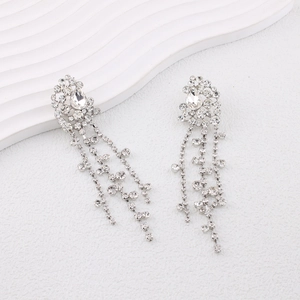 Elegant silver tassel earrings with pear-shaped stones and shimmering rhinestones