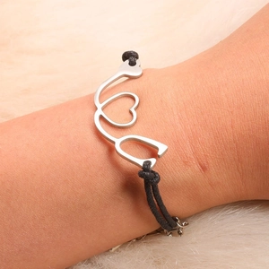 Detailed shot of nurse stethoscope charm bracelet on wrist with adjustable black rope