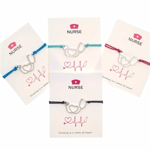 Detail view of heart stethoscope charms on wax rope bracelets in four distinct colors