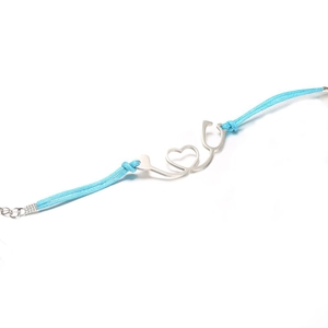 Macro shot of blue woven stethoscope heart charm bracelet on a clean white background