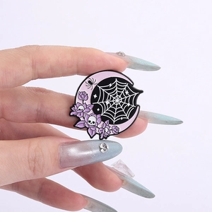 Detailed close-up of gothic enamel brooch with purple crescent moon and skull design