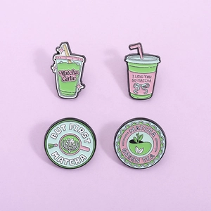 Set of four cute matcha green tea enamel pins with creative cartoon drink designs
