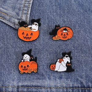 Set of 4 cute Halloween enamel pins featuring ghost, black cat and pumpkin on denim