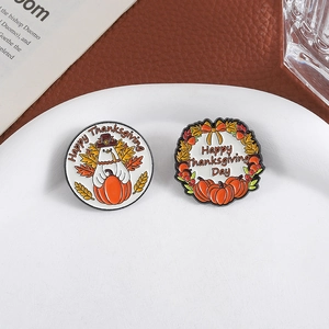 Festive Thanksgiving enamel pin set featuring turkey and pumpkin designs on white plate