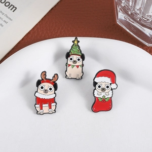 Detailed view of three festive Christmas pug enamel brooches with tree and reindeer motifs