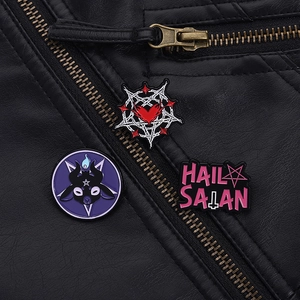 Gothic enamel pin set with goat head and heart patterns on black leather jacket