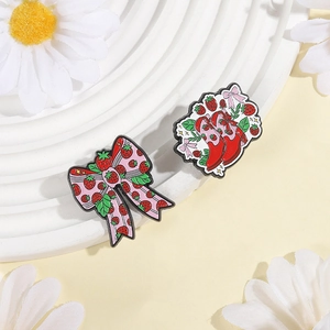 Cute strawberry bow and red boot enamel pins set on decorative floral background