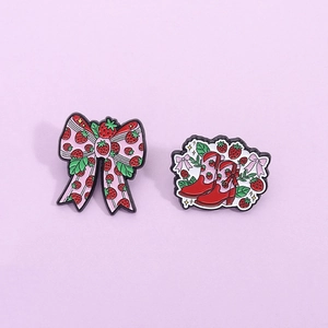 Cute strawberry bow and boot enamel pin set with pink accents on light purple background